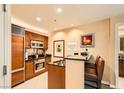 Modern kitchen with stainless steel appliances and breakfast bar at 145 E Harmon Ave # 2002, Las Vegas, NV 89109