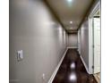 Long hallway with dark hardwood floors and recessed lighting at 150 Las Vegas Blvd # 907, Las Vegas, NV 89101