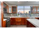 Modern kitchen with wood cabinets and city views at 150 Las Vegas Blvd # 907, Las Vegas, NV 89101