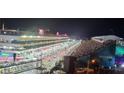 Night view of Formula 1 race track, showing cars and spectators at 205 E Harmon Ave # 704, Las Vegas, NV 89169