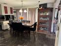 Dining room with a large table and dark floors at 2180 Palora Ave, Las Vegas, NV 89169