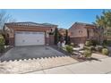 Single-story home with a two-car garage and manicured landscaping at 2261 Boutique Ave, Henderson, NV 89044