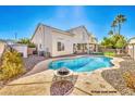 Inviting kidney-shaped pool with a fire pit in the backyard at 2374 Thayer Ave, Henderson, NV 89074