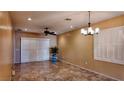 Spacious dining area with tile floors, ceiling fan, and large windows at 2575 Red Planet St, Henderson, NV 89044