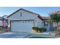 Single-story home with a two-car garage and landscaped front yard at 2575 Red Planet St, Henderson, NV 89044