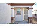 Inviting house exterior featuring a covered entryway, security door, and stone accents at 2575 Red Planet St, Henderson, NV 89044