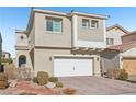 Tan two-story house with a two-car garage and landscaped front yard at 266 Cullerton St, Las Vegas, NV 89148