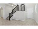 Modern staircase with dark wood railing and tile flooring at 266 Cullerton St, Las Vegas, NV 89148