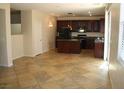 Open concept kitchen with island and tile flooring at 3309 Conterra Park Ave, North Las Vegas, NV 89081