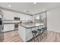 Modern, updated kitchen with white cabinets, a large island with seating, and stainless steel appliances at 43 Strada Loreto, Henderson, NV 89011