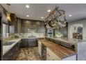 Modern kitchen with marble countertops and wooden island at 4412 Desert Park Ave, North Las Vegas, NV 89085