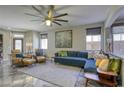 Spacious living room with a blue sectional sofa and a large piece of art at 4412 Desert Park Ave, North Las Vegas, NV 89085