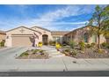 Tan house with a three-car garage and desert landscaping at 4618 Atlantico St, Las Vegas, NV 89135