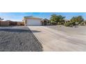 House exterior showcasing a driveway and desert landscaping at 4911 E Parkwood Dr, Pahrump, NV 89061