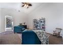 Living area featuring teal sofas, a bookshelf, and a rocking chair at 4911 E Parkwood Dr, Pahrump, NV 89061