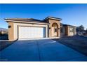 New home exterior featuring a garage and neutral tones at 521 Antelope Ave, Pahrump, NV 89060