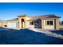 New construction home features a neutral exterior and a welcoming front porch at 521 Antelope Ave, Pahrump, NV 89060