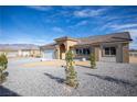 Attractive tan single story home with tile roof and low maintenance front yard at 521 Antelope Ave, Pahrump, NV 89060