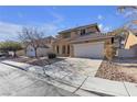 Two-story house with a tan exterior, green door and a two-car garage at 5313 Dawn Break Canyon St, North Las Vegas, NV 89031