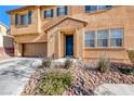 House exterior featuring a teal front door and rock landscaping at 5428 Brazelton St, North Las Vegas, NV 89081