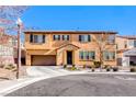 Two-story home featuring a well-manicured lawn, a two car garage and a classic Mediterranean-style roof at 5428 Brazelton St, North Las Vegas, NV 89081