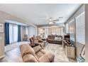 Spacious living room with comfortable seating, a ceiling fan, and an open layout for entertaining at 5428 Brazelton St, North Las Vegas, NV 89081