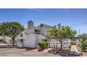 Home exterior featuring neutral stucco, a chimney, and desert landscaping at 5655 Vineyard Ln # 0, Las Vegas, NV 89110