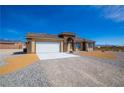 Inviting single story home with mountain views, a two-car garage, and gravel landscaping at 5821 Genoa Ave, Pahrump, NV 89060