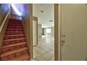 Inviting entryway with staircase and tile flooring that leads into a spacious living area at 6113 Breeders Cup St, Las Vegas, NV 89130