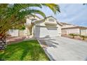 Beautiful two-story home featuring a two-car garage, tile roof, and low maintenance landscaping at 6113 Breeders Cup St, Las Vegas, NV 89130