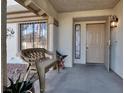 Covered front porch with a bench and decorative accents at 6233 Morning Splendor Way, Las Vegas, NV 89110