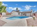 Backyard featuring a refreshing in-ground pool, patio area, and privacy fence, perfect for outdoor relaxation at 6436 Whippoorwill Way, Las Vegas, NV 89103