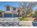 Two-story house with a landscaped yard, two-car garage, and gated entry at 6901 Copper Kettle Ave, Las Vegas, NV 89130