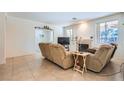 Bright living room with tile floors, fireplace, and two recliner sofas at 6901 Copper Kettle Ave, Las Vegas, NV 89130