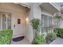 Front entrance with white door, sidelights, and potted plants at 6948 Emerald Springs Ln, Las Vegas, NV 89113