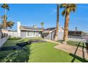 Single-story house with solar panels, gray exterior, and artificial turf at 7026 Westpark Ct, Las Vegas, NV 89147