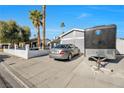 Single-story house with a gray exterior, a car, and a trailer in the driveway at 7026 Westpark Ct, Las Vegas, NV 89147