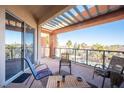 Private balcony with outdoor furniture and scenic view at 79 E Agate Ave # 306, Las Vegas, NV 89123