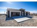 Well-designed home featuring an attached garage, a spacious driveway, and a modern aesthetic at 801 Fort Churchill Rd, Pahrump, NV 89060