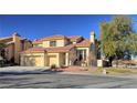 Two-story house with tan exterior, tile roof, and two-car garage at 8916 Stafford Springs Dr, Las Vegas, NV 89134