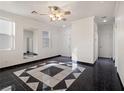 Living room with a geometric tile floor, mirror, and high ceilings at 9523 Cherrydale Ct, Las Vegas, NV 89147