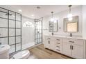 Spa-like bathroom with double vanity, frameless shower, and modern fixtures at 10968 Fintry Hills St, Las Vegas, NV 89141