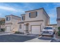 Two-story house with attached garage, and driveway parking at 1167 Vacation Valley Ave, Las Vegas, NV 89183