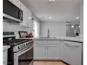 Modern kitchen with stainless steel appliances and white cabinets at 1167 Vacation Valley Ave, Las Vegas, NV 89183