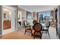 Bright dining area with glass table and four chairs, offering a view into the living room at 135 E Harmon Ave # 2501, Las Vegas, NV 89109