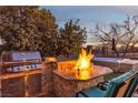 Backyard grill and fire pit create the perfect outdoor living space at 138 Reflection Cove Dr, Henderson, NV 89011