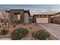 Single-story home with stone accents and a two-car garage at 138 Reflection Cove Dr, Henderson, NV 89011