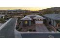 Stunning aerial view of a single Gathering home with desert landscaping, a two-car garage, and gorgeous mountain views at 138 Reflection Cove Dr, Henderson, NV 89011