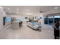 Open concept kitchen with island, stainless steel appliances, and blue tile backsplash at 138 Reflection Cove Dr, Henderson, NV 89011