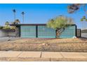 Midcentury modern home with a unique blue block wall facade at 1558 Aztec Way, Las Vegas, NV 89169